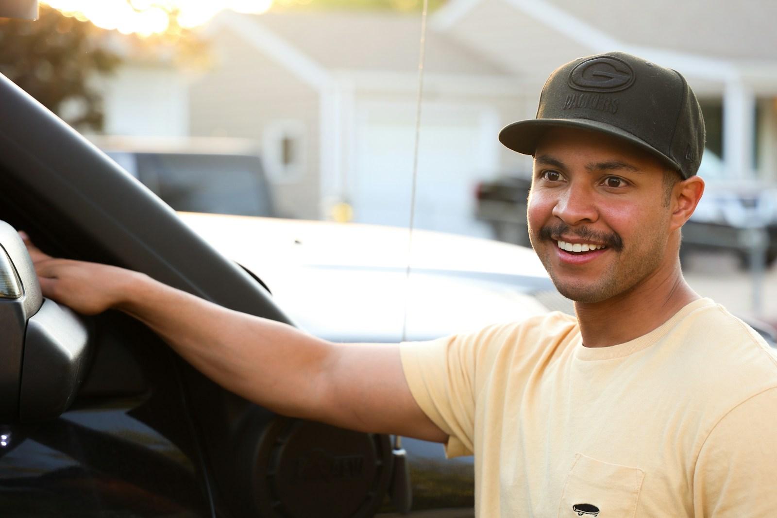 A smiling man behind the wheel