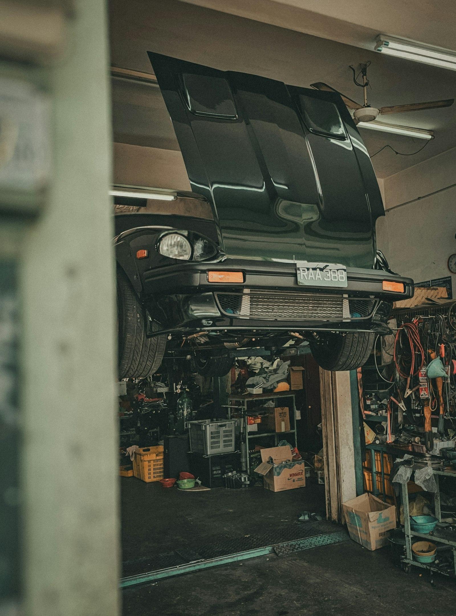 A car raised on a lift in the garage
